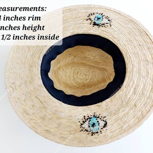 May include: A straw hat with a 4 inch rim, 5 inch height, and 7 1/2 inch inside diameter. The hat has a black band and turquoise and black beaded embellishments.