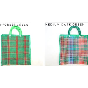 May include: Two square tote bags with green handles. The left bag is labeled MEDIUM FOREST GREEN and features a green and red plaid pattern. The right bag is labeled MEDIUM DARK GREEN and features a multi-colored plaid pattern with red, blue, and green.