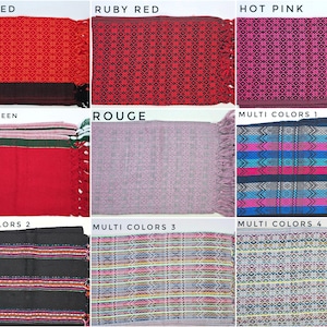 May include: A collection of nine rectangular woven textiles featuring various patterns and color combinations including brick red, ruby red, hot pink, red and green, rouge, and four multi-colored designs with fringe edges and geometric motifs.