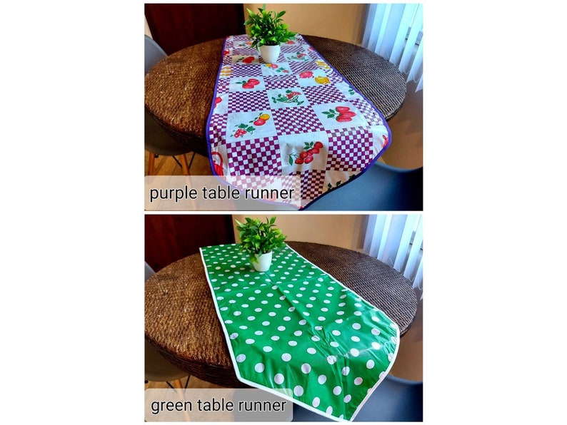 May include: Two table runners, one purple with a checkered pattern and fruit design, and one green with white polka dots. Both runners are on a brown wicker table with a plant in a pot on each runner.
