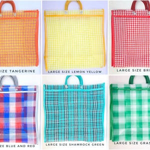 May include: A collection of six large rectangular tote bags made of a semi-transparent mesh material. Each bag features a distinct plaid or gingham pattern in colors including tangerine, lemon yellow, brick red, blue and red, shamrock green, and grass green. Each bag has two matching handles attached with metal rivets.