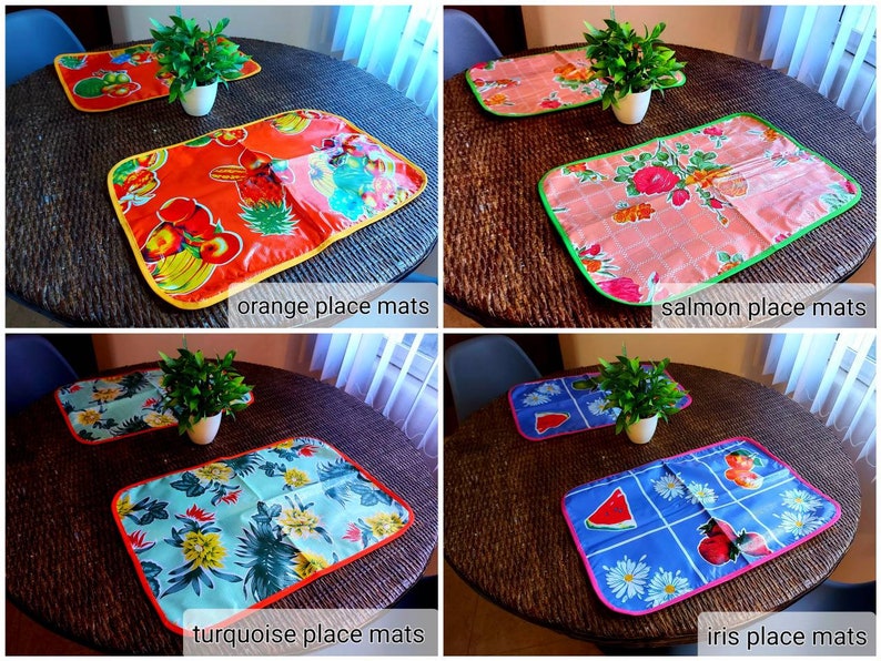 May include: Four placemats with different designs and colors. The placemats are on a woven surface. The placemats are labeled "orange place mats", "salmon place mats", "turquoise place mats", and "iris place mats".