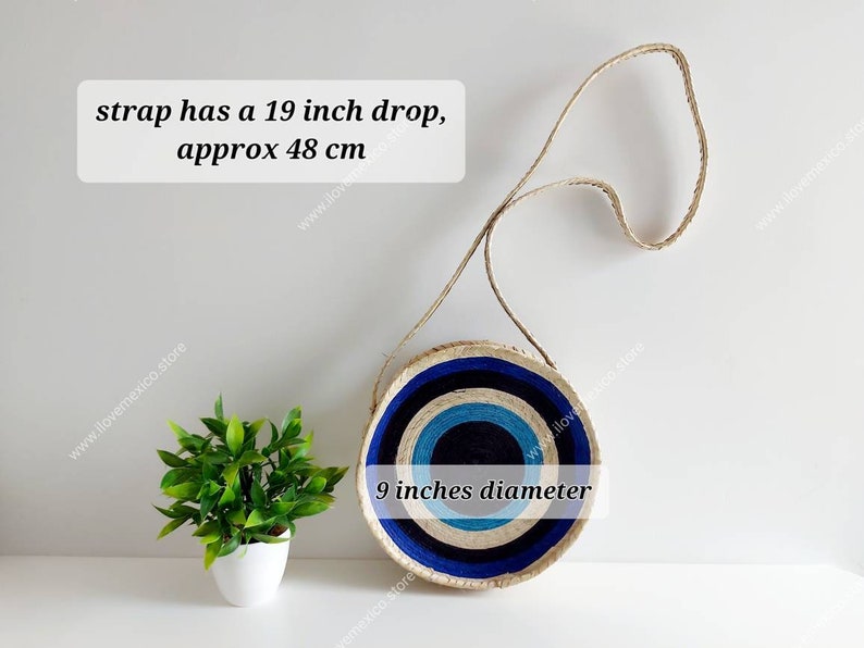 May include: A round straw bag with blue and white stripes. The bag has a 19 inch drop strap and is 9 inches in diameter. "strap has a 19 inch drop, approx 48 cm" and "9 inches diameter" are written on the bag.