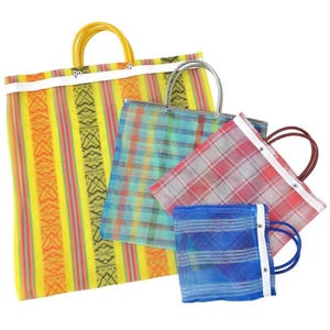 May include: A collection of four rectangular tote bags in varying sizes, featuring translucent mesh material with colorful patterns including yellow stripes, teal plaid, red plaid, and blue horizontal lines, each with matching plastic handles.