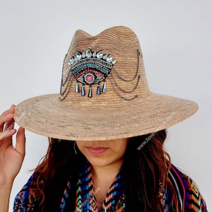 Mexican straw hat with embroidered eye decoration
