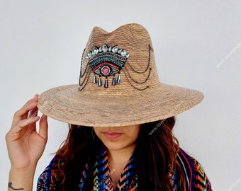 Mexican straw hat with embroidered eye decoration