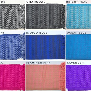 May include: A collection of nine rectangular woven textiles with fringe, labeled as Ash Black, Charcoal, Bright Teal, Blue Jeans, Indigo Blue, Ocean Blue, Fuschia, Flamingo Pink, and Lavender, each featuring distinct geometric patterns.