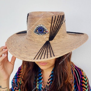 Mexican straw hat with embroidered eye decoration