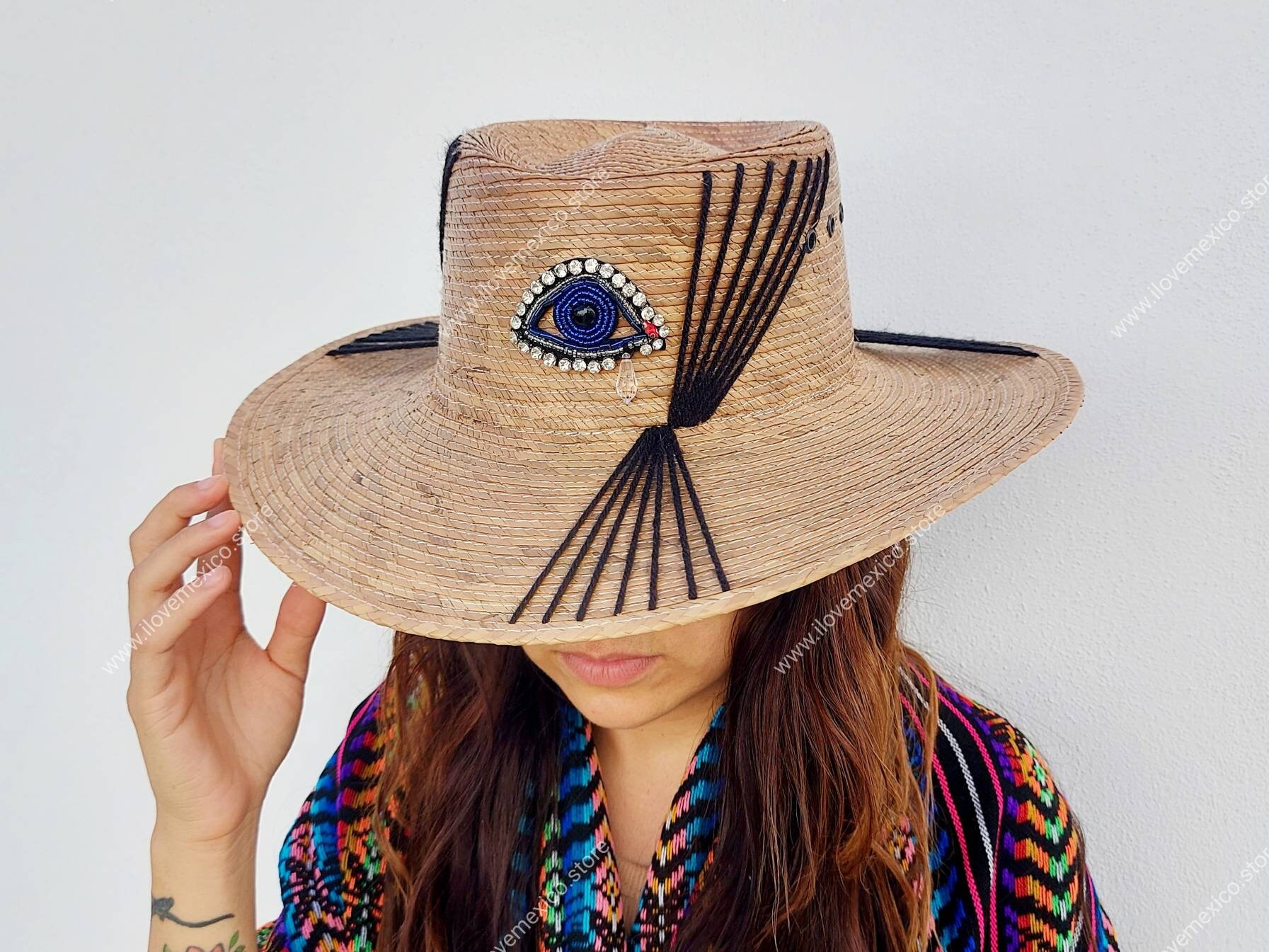 Mexican straw hat with embroidered eye decoration