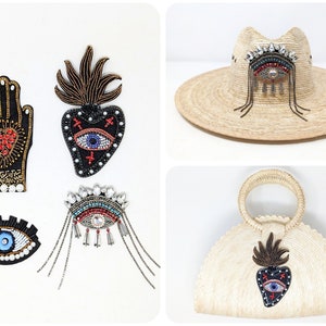 May include: Four beaded patches with an evil eye design. The patches are black with blue, red, and gold beads. The patches are on a white background. The patches are for sewing or gluing onto clothing, bags, or other items.