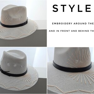 May include: A light beige fedora hat featuring a black leather band, cream-colored sunburst embroidery on the crown, and a zigzag stitched pattern along the brim. Text on the image reads: STYLE 3, EMBROIDERY AROUND THE BRIM AND IN FRONT AND BEHIND THE CROWN.