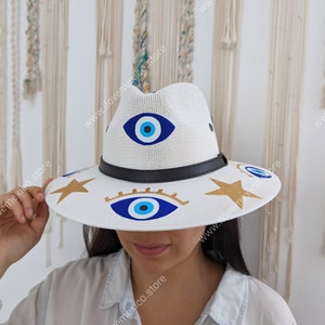 Mexican straw hat with hand painted eye decoration