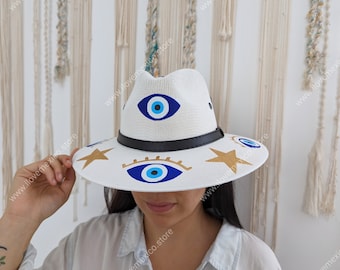 Sombrero de paja mexicano con decoración de ojos pintados a mano.