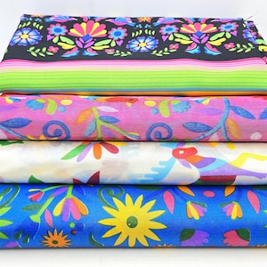 May include: A stack of four folded fabric pieces. The top piece is black with colorful floral patterns and horizontal stripes. The second is pink with floral motifs. The third is white with colorful animal and leaf prints. The bottom is blue with yellow flowers.