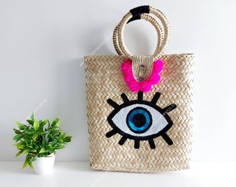 Large evil eye straw tote with pompoms