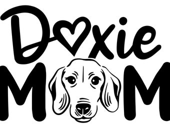 May include: Black and white graphic design with the text "Doxie Mom" and a heart. A black and white illustration of a dachshund dog's head is in the center of the design.