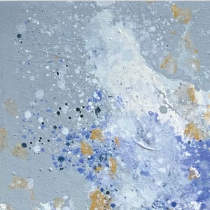 Pu&ograve; includere: Dipinto astratto con sfondo grigio chiaro e schizzi di vernice bianca, blu e dorata.