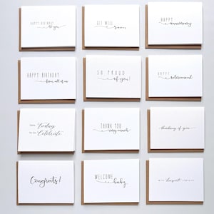 May include: A collection of twelve white greeting cards with black text and brown envelopes. The cards feature various phrases including Happy Birthday to you, Get Well Soon, Happy Anniversary, Happy Birthday from all of us, So Proud of you!, Happy Retirement, Date: Today To Do: Celebrate, Thank You very much, thinking of you, Congrats!, Welcome baby, and with deepest sympathy.