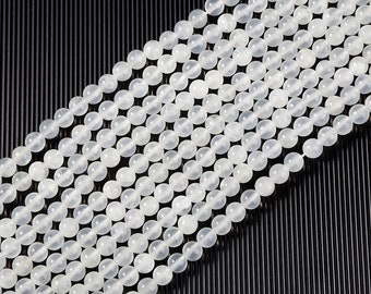 May include: A strand of white round beads, made of natural stone, for jewelry making.