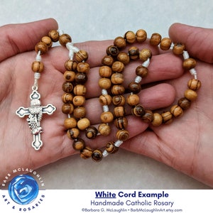 I inspect each bead when stringing rosaries by hand. This ensures that each olive wood rosary will be durable and last a long time. Olive wood rosary beads very in color and shape, adding to the beauty of each rosary.