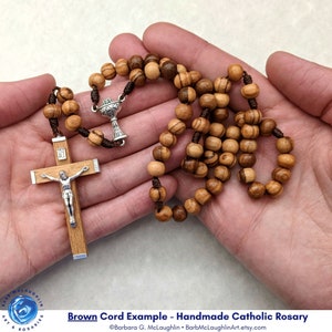Hand made Catholic rosary with 7mm olive wood rosary beads, chalice centerpiece, traditional wooden crucifix, and brown nylon cord.