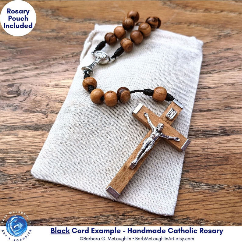 Handmade First Communion rosary with movable 7mm Holy Land olive olive wood beads, metal chalice centerpiece, Italian-made crucifix, and black nylon cord. This rosary includes a muslin rosary pouch (approximately 3 inches by 4 inches).