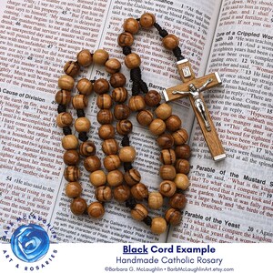 Each five decade rosary is strung by hand with two nylon cords for durability. The 8mm olivewood beads (large size) move between each decade of 10 beads. Traditional and classic wooden rosary for men or women.