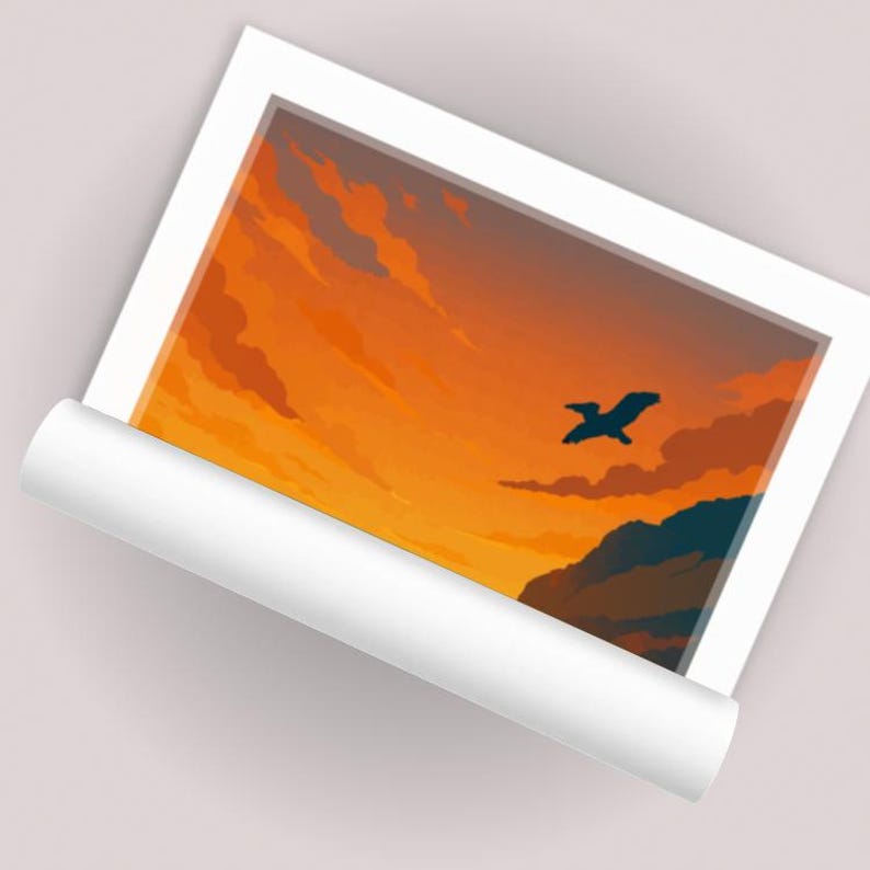 May include: A framed art print featuring a vibrant sunset scene. The artwork depicts an orange and yellow sky with clouds, a dark silhouette of a bird in flight, and a mountain range. The print is framed in a white border.