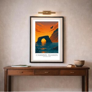 May include: Framed art print featuring a scenic view of the Channel Islands National Park. The artwork depicts a rock archway over the ocean under a vibrant orange and blue sunset. The text "Channel Islands National Park" is at the bottom.