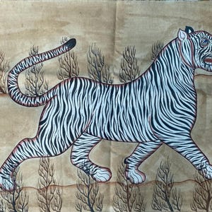 May include: An illustration of a tiger with black and white stripes, depicted in a walking pose. The tiger's tongue is visible, and the artwork is set against a tan background with stylized trees.