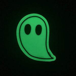 May include: A green glow-in-the-dark ghost sticker with black eyes.