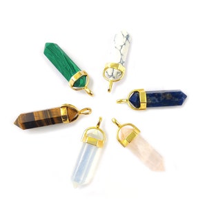 May include: Six gold-capped crystal point pendants with different colored stones: green malachite, white tiger's eye, blue lapis lazuli, clear quartz, pink rose quartz, and brown tiger's eye.
