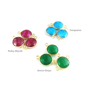 May include: Three sets of gemstone connector charms with gold-toned accents. The charms are in the shapes of round cabochons. The first set is ruby (dyed) red, the second is turquoise blue, and the third is green onyx.