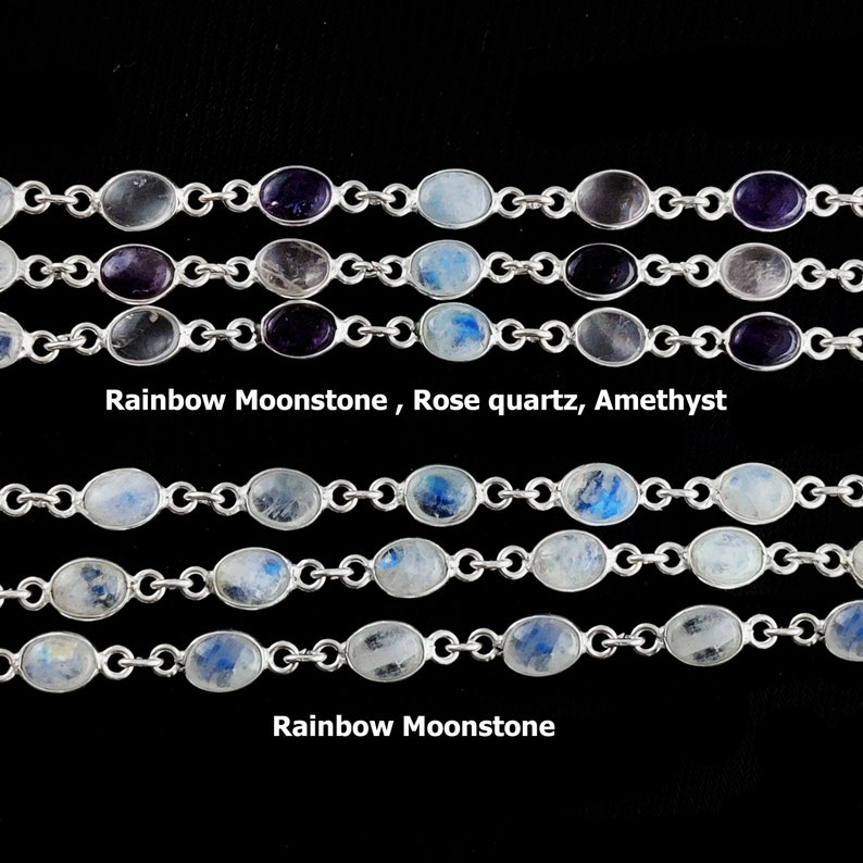 May include: Five silver chains with oval-shaped gemstones. The top three chains feature amethyst, rose quartz, and rainbow moonstone. The bottom two chains feature rainbow moonstone.