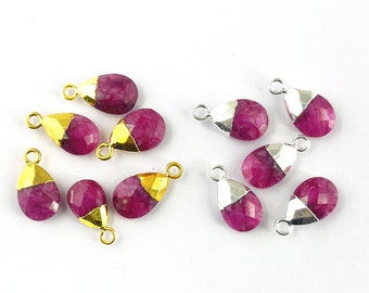 May include: Assortment of pink gemstone teardrop pendants with gold and silver accents. The pendants have a faceted design and are ready to be used in jewelry making.