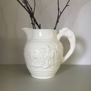 Old small milk jug in ivory-colored art nouveau style biscuit