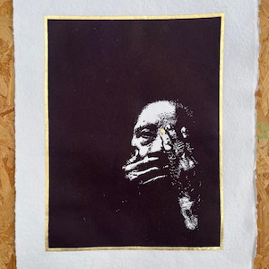 May include: Black and white art print featuring a profile of a person with their hand covering their mouth. The artwork is set against a black background with a gold border, on a white paper with rough edges.
