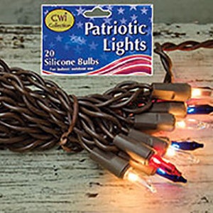 May include: A bundle of patriotic string lights with red, white, and blue silicone bulbs. The lights are wrapped together with a brown wire and are displayed with a product label that reads "Patriotic Lights".