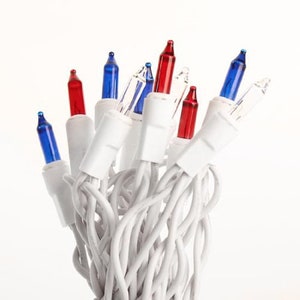 May include: A string of white Christmas lights with red, blue, and clear bulbs. The lights are tangled together.