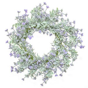 May include: A green and purple artificial flower wreath with small purple flowers and green leaves.