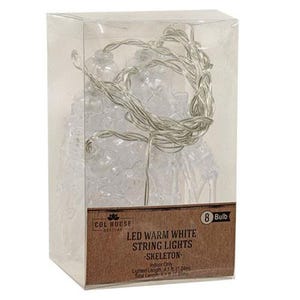 May include: A clear plastic box containing 8 LED warm white skeleton string lights. The label reads: COL HOUSE, 8 Bulb, LED WARM WHITE STRING LIGHTS, SKELETON, Indoor Only, Lighted Length 4.1 ft (1.24m), Total Length 6 ft (1.83m).