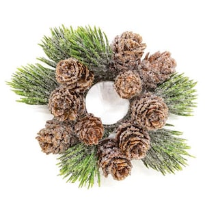 May include: A festive candle ring featuring brown pinecones and green pine needles dusted with white. The candle holder has a white center and is perfect for holiday decor. The arrangement is circular and sits on a white background.