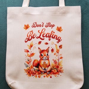 Cute Autumn Theme Tote Bag, Don't Stop Be Leafing, Humorous with Cute Squirrel & Fall Leaves, Durable Medium Size Tote Bag in Natural White image 1