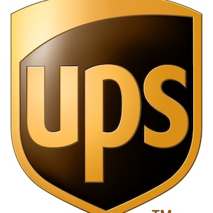 May include: A brown shield-shaped logo with the word "UPS" in gold letters. The logo has a gold border and a gold background. The letters "TM" are in white below the logo.