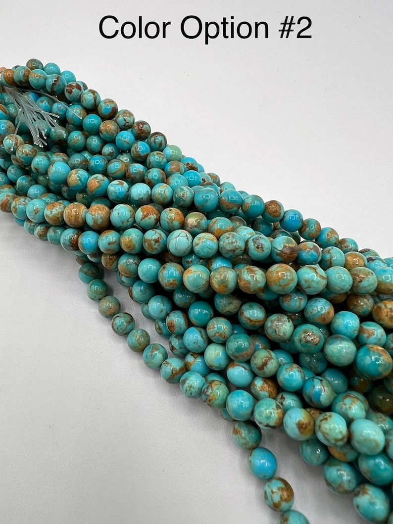 May include: A strand of turquoise blue and brown round beads. The beads have a mottled pattern and are approximately 6mm in diameter.