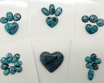 May include: Six turquoise cabochons in various shapes, including hearts, paw prints, and flowers. The turquoise is a blue-green color with black matrix.