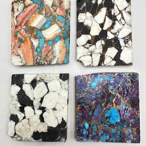 May include: Four rectangular stone tiles with distinct patterns. One tile has orange, white, and turquoise colours. Another shows black and white fragments. The third has black and white patterns, and the last is a mix of purple, turquoise, and gold.