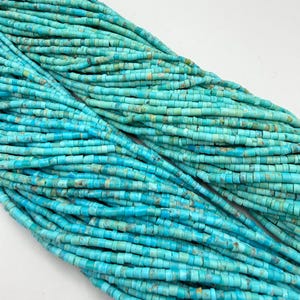 May include: Multiple strands of small, cylindrical turquoise beads arranged in a diagonal pattern. The beads feature varying shades of bright blue, teal, and light green with natural brown matrix inclusions, creating a textured appearance.