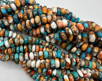 May include: A strand of multi-colored gemstone beads. The beads are round and have a mottled appearance with shades of turquoise, orange, white, and brown.