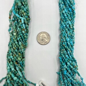 May include: Two strands of turquoise chip beads, labelled #3 and #4. The beads are a mix of light and dark blue turquoise, with some brown inclusions. The beads are strung on a white cord and are approximately 18 inches long.